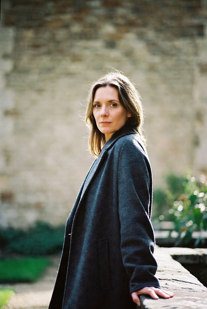 Eleanor Ashby, founder of Abbey Creed Tours, photographed beside a churchyard wall.