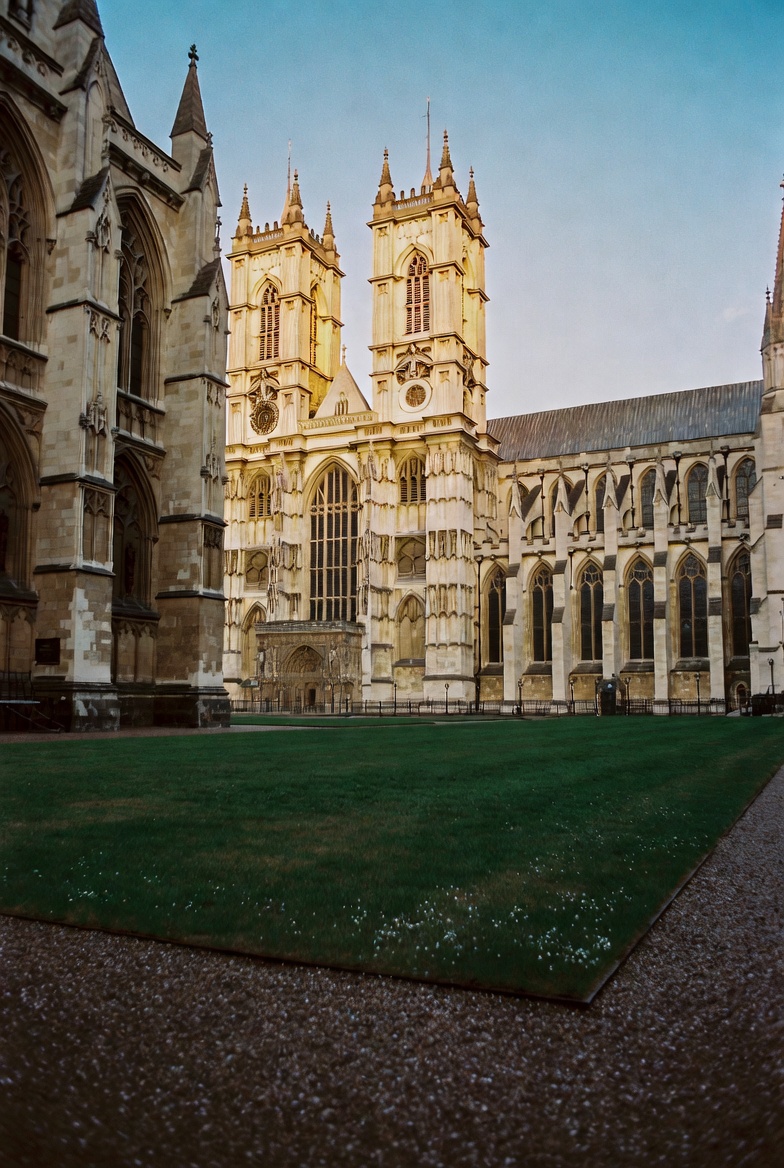 A walker's hand resting on the rope barrier outside the Abbey's north door.