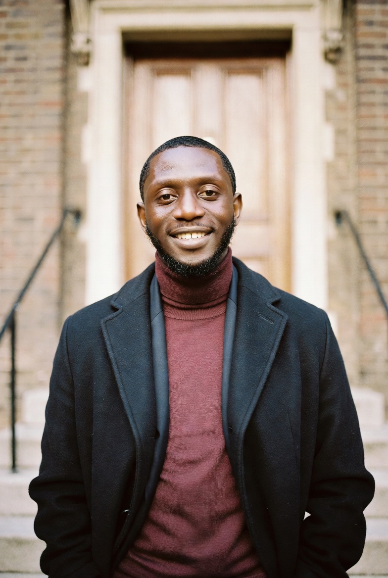 Daniel Okonkwo photographed in front of a London chapel facade.