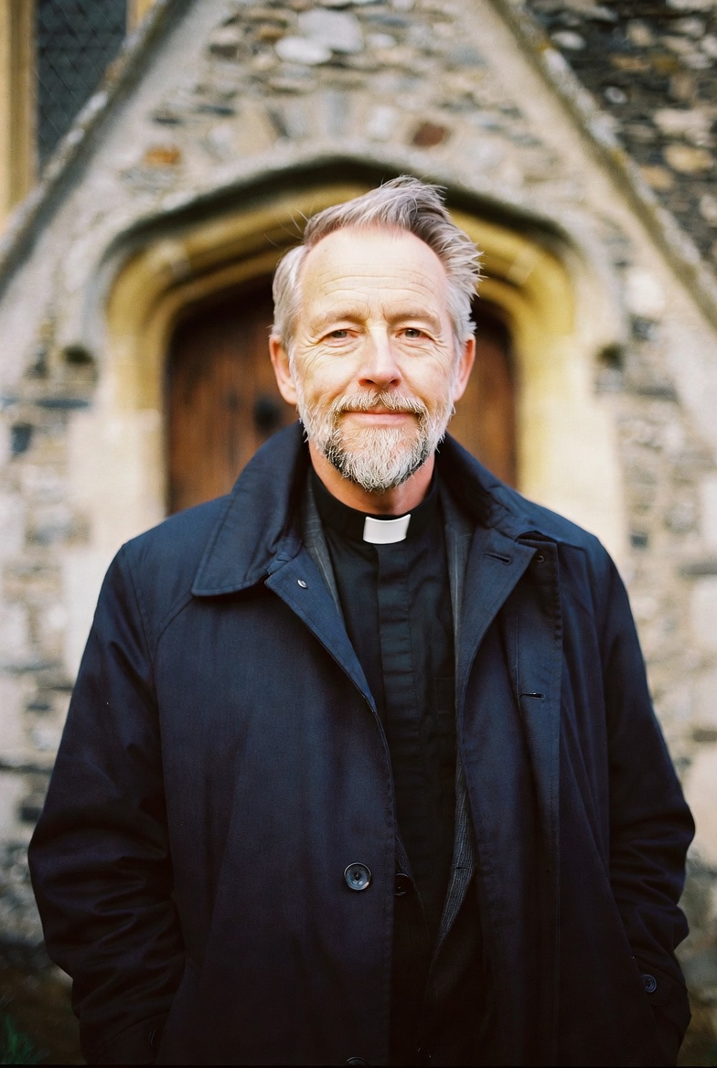 Reverend Thomas Whitfield photographed outside an English parish church.